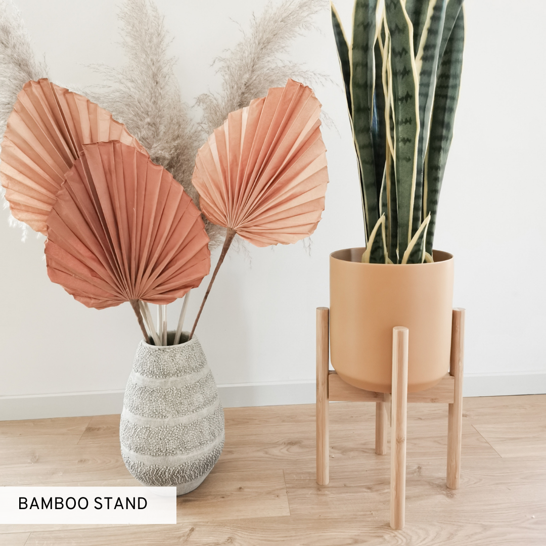Indoor plant stand made of wood to match boho and rustic interiors.