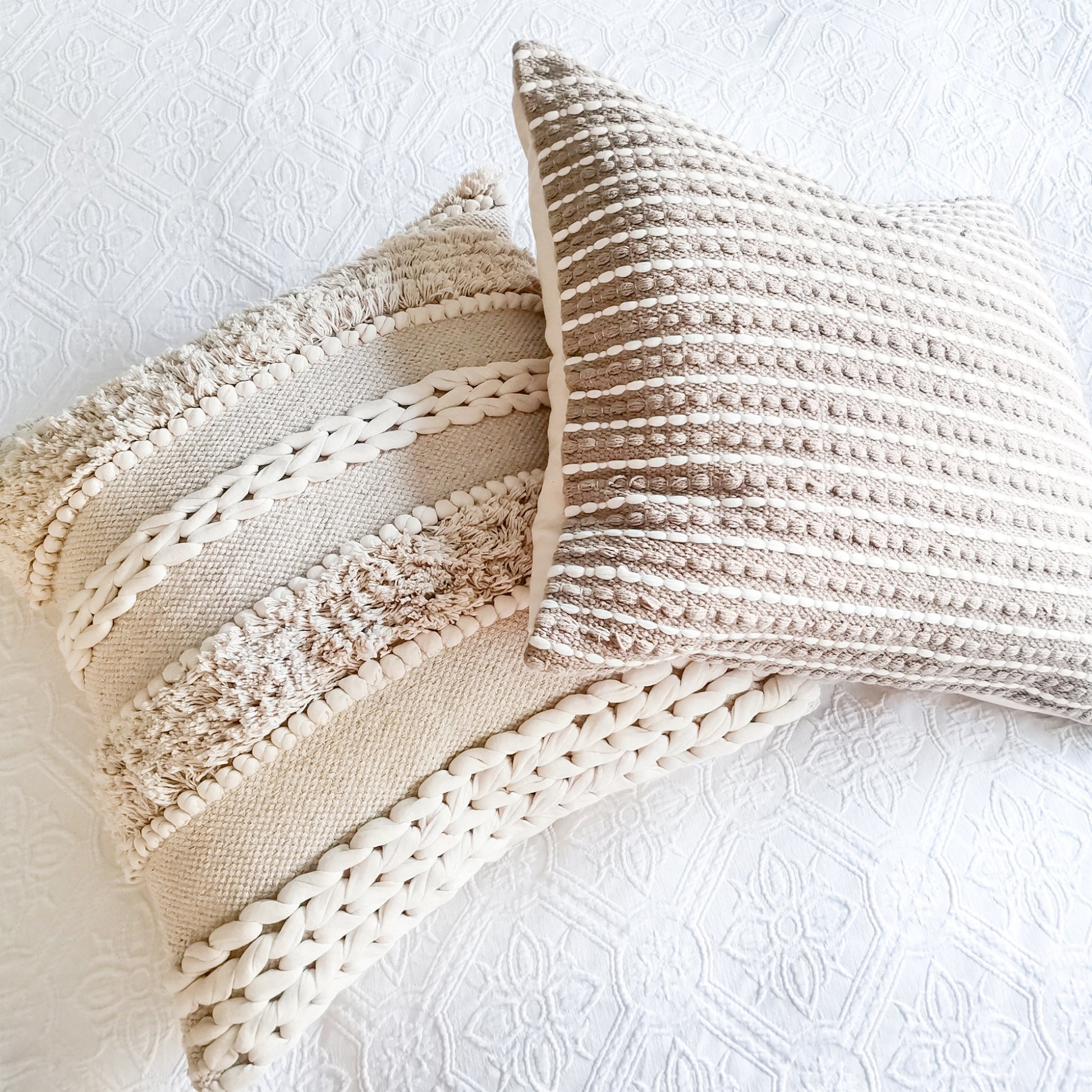 Boho pillows with stripe patterns and tufted details