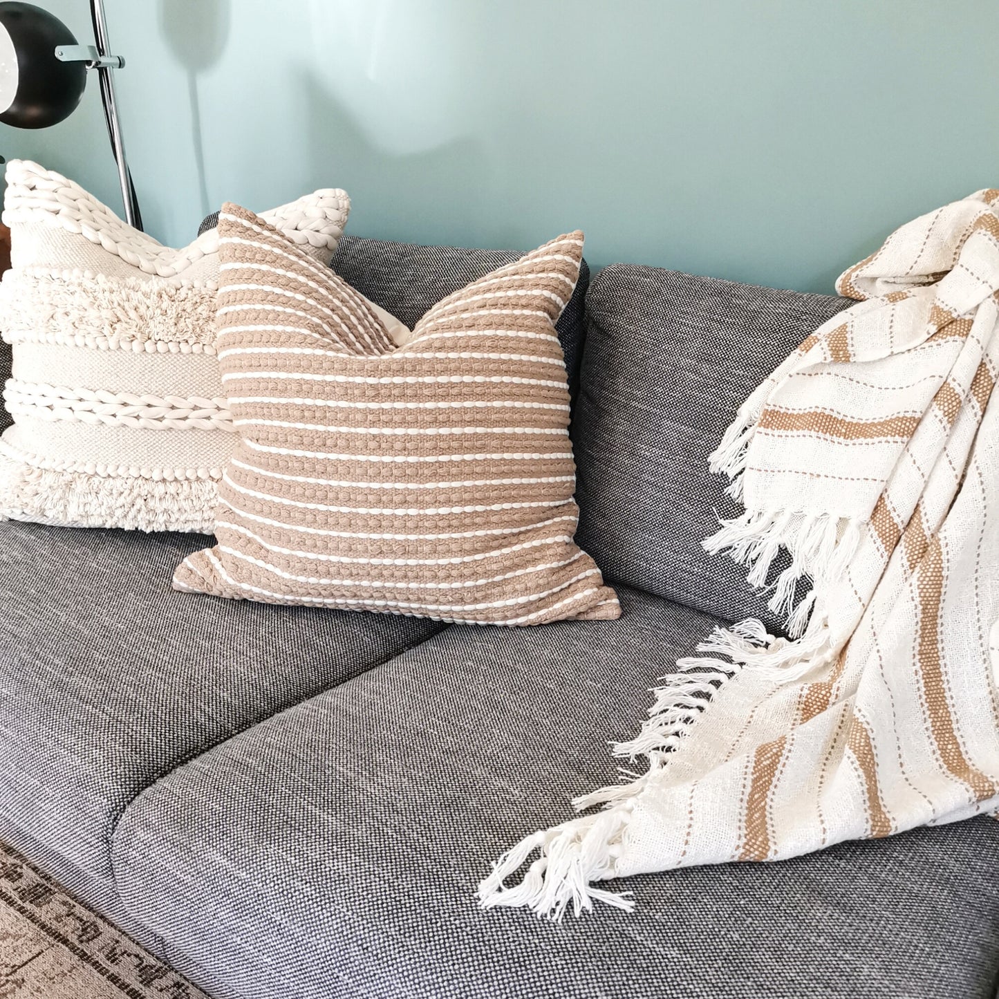 Boho pillows and blankets in a living room sofa