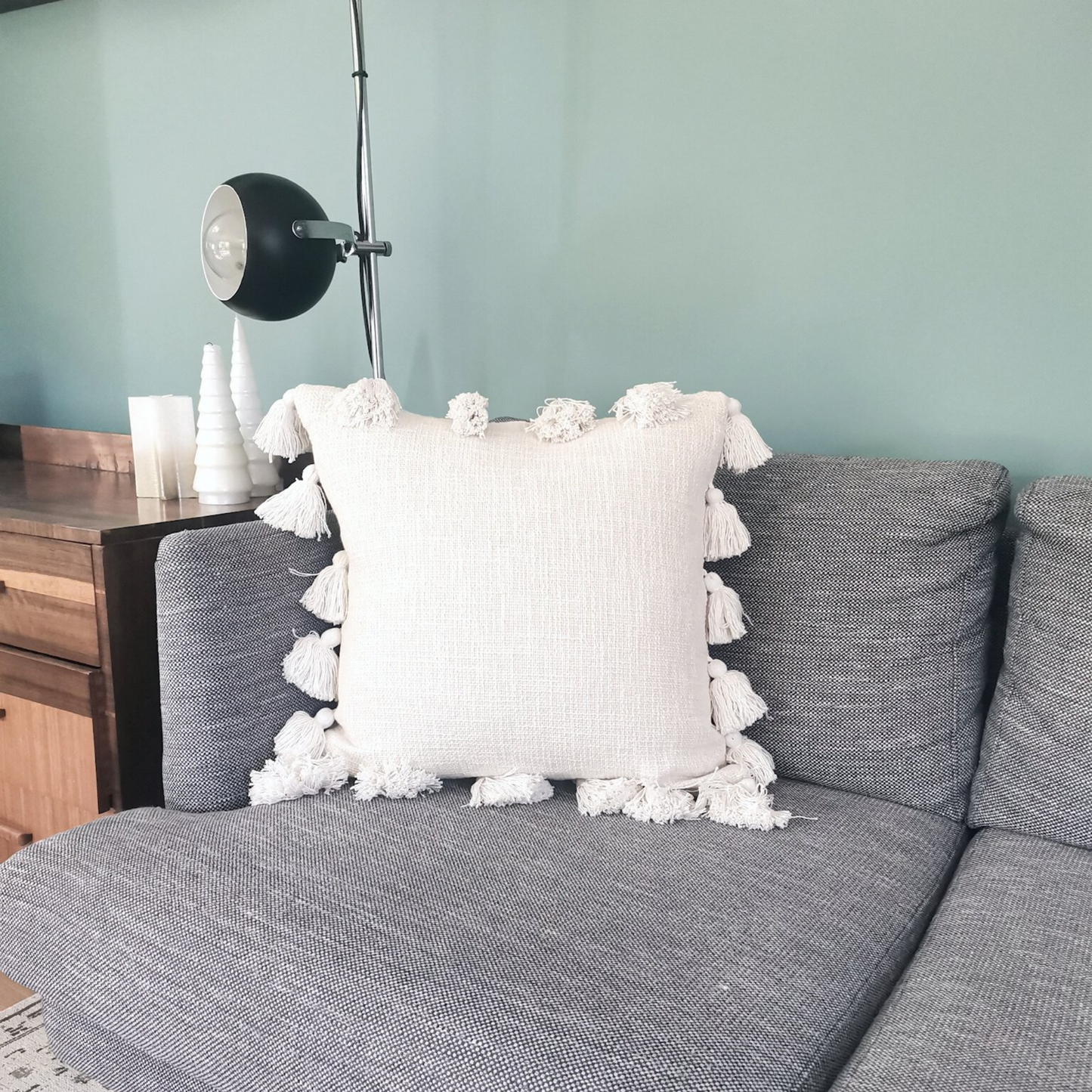 Pom poms cushion in white cream color