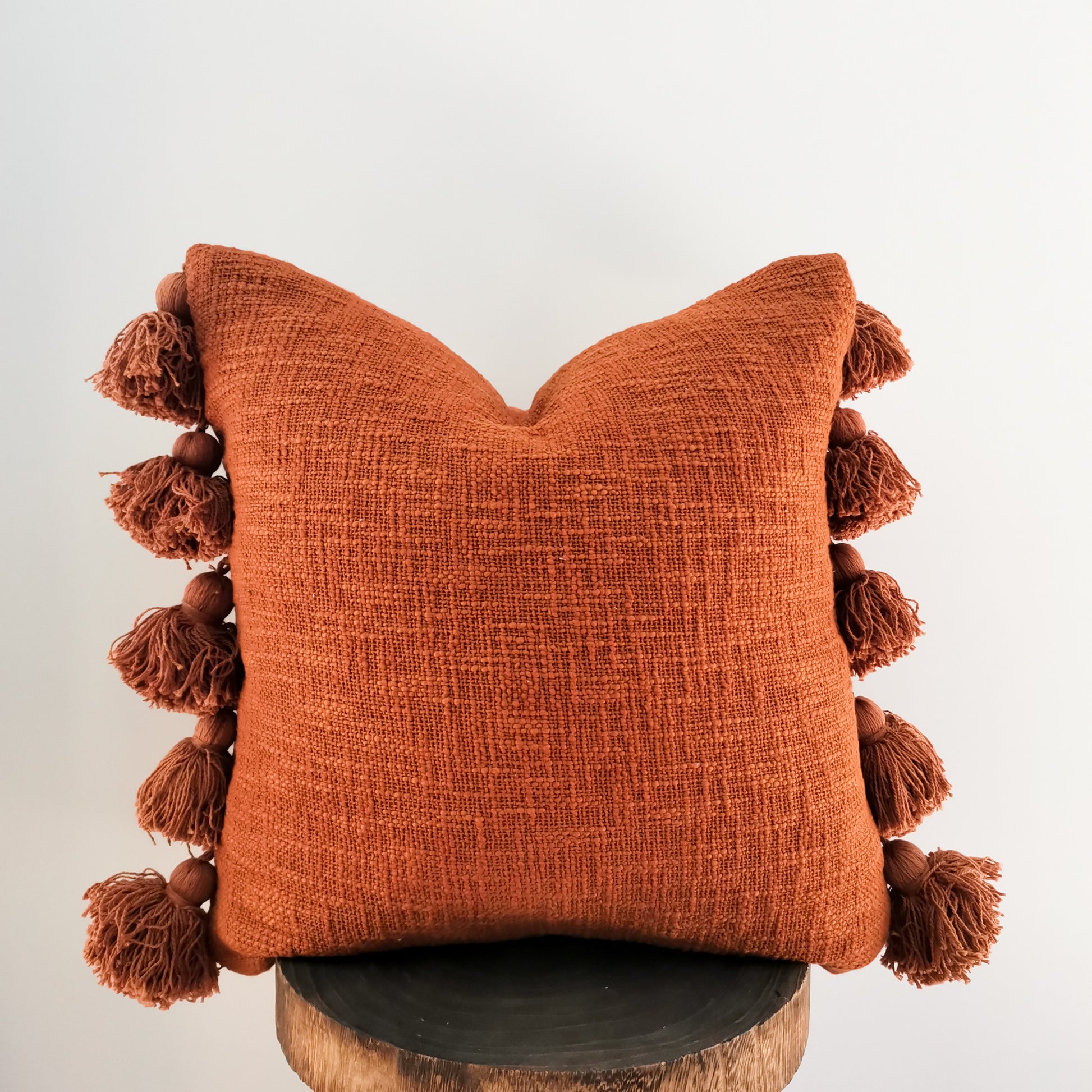 Rust tassel cushion boho design