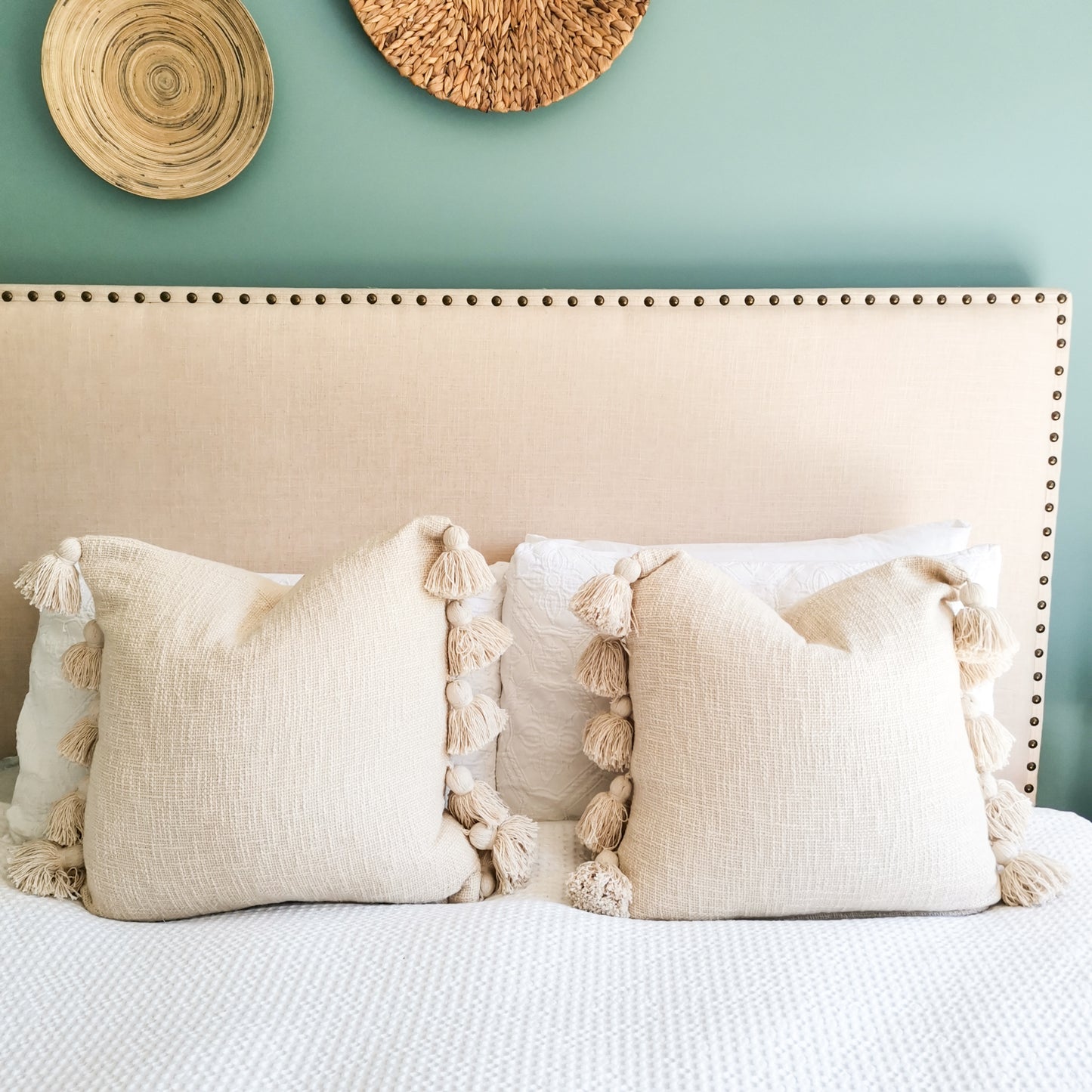 Boho bedroom with white tassel pillow